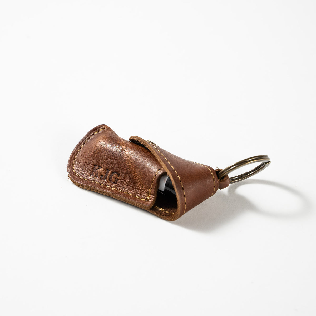 Keychain lip balm holder featuring button snap closure. Made with full-grain American leather. Customize with your initials. Makes for the perfect gift or stocking stuffer. Available in black or brown leather.