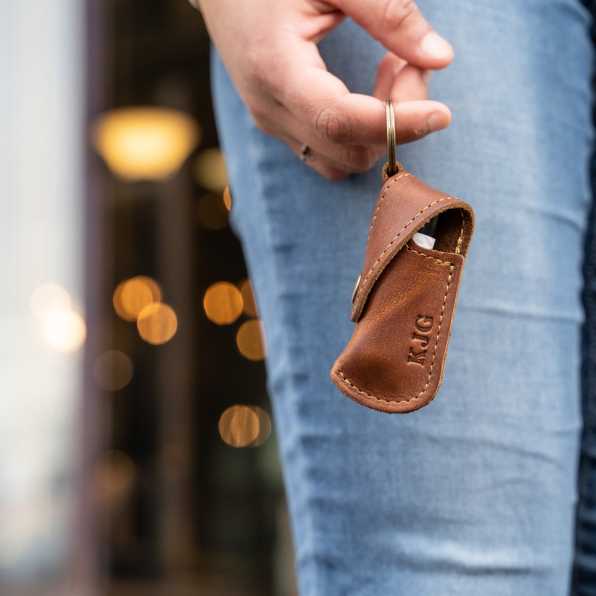 Keychain lip balm holder featuring button snap closure. Made with full-grain American leather. Customize with your initials. Makes for the perfect gift or stocking stuffer. Available in black or brown leather.