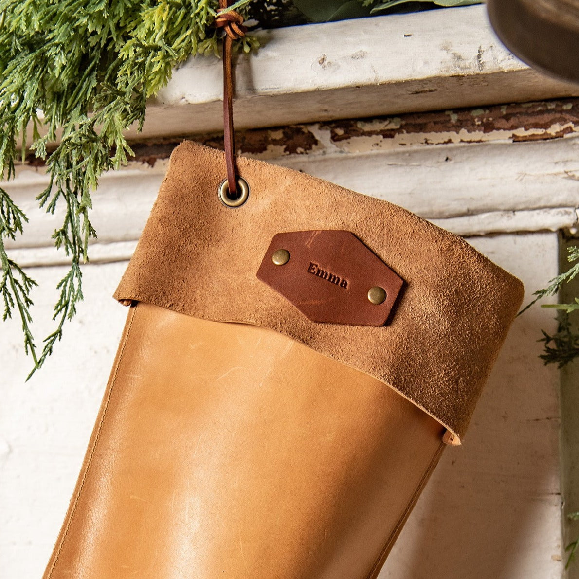 Hand-crafted leather stocking in brown and tan, made from premium quality leather for durability. Designed to enhance holiday decor and create lasting family memories.