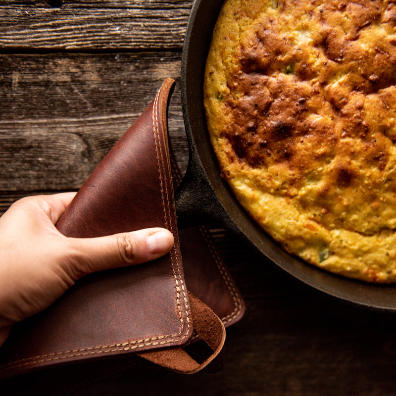 Fine leather trivet being used to hold a pan