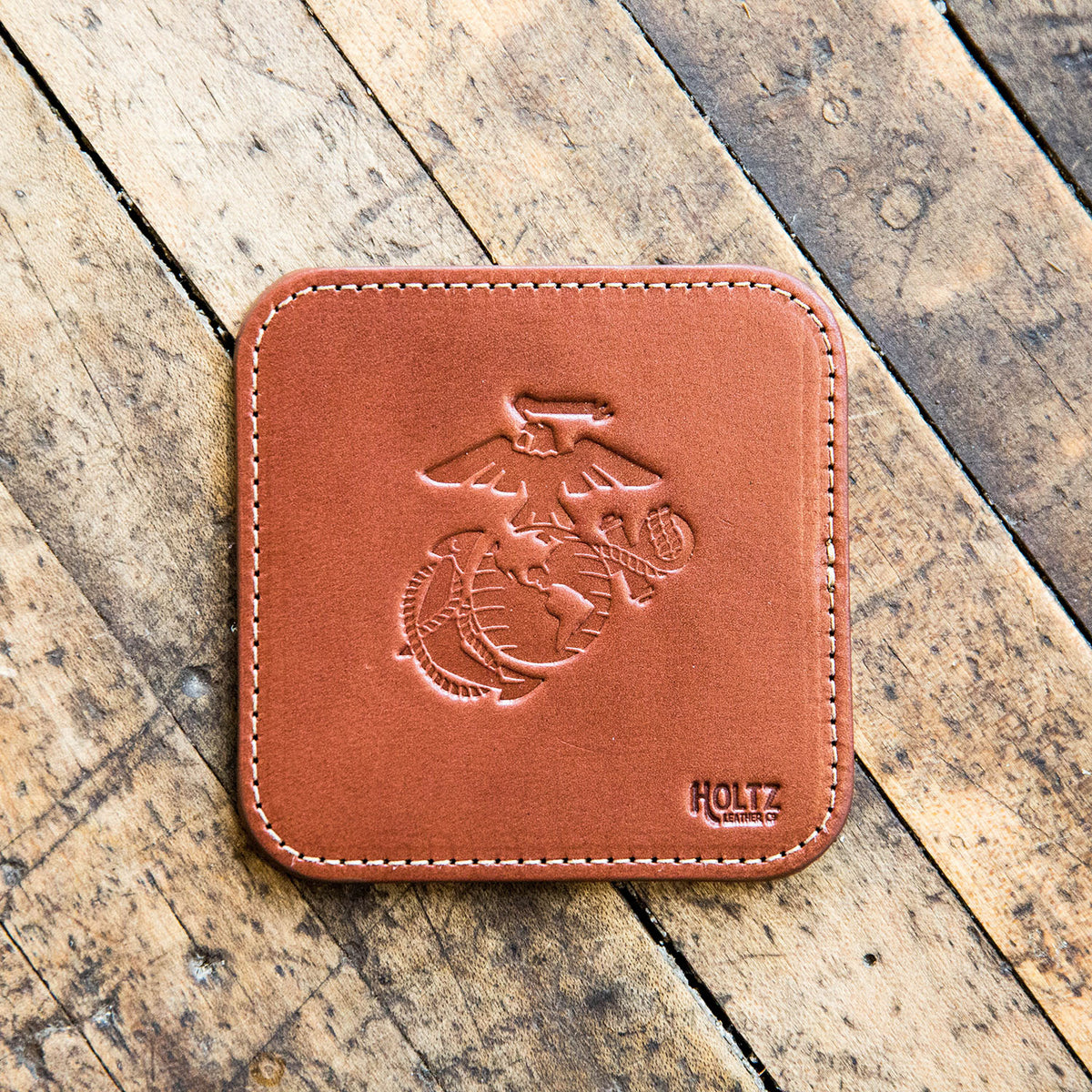 Fine leather coaster with Marine Corps logo and Shoporiaz Co logo
